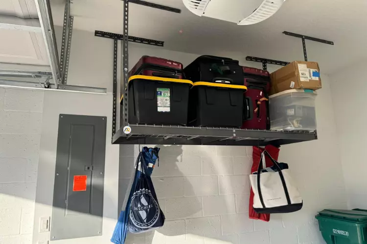 Heavy-duty overhead garage storage rack installation in Naples, FL.